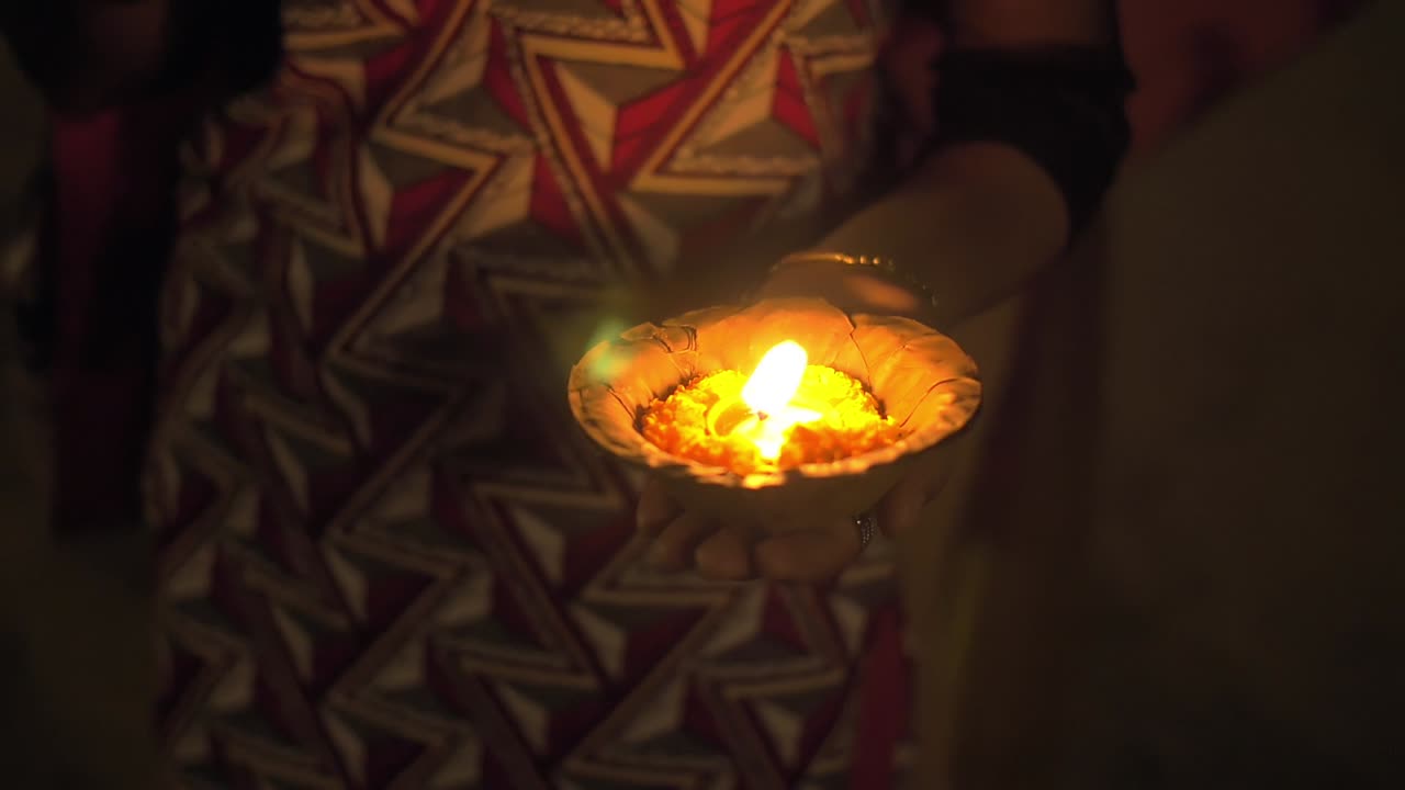 mujer sosteniendo una vela puja en ganga aarti varanasi