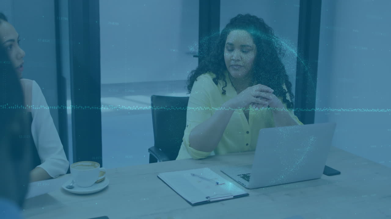 Businesswoman at desk with laptop and coffee, digital data animation overlay