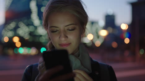 portrait-of-attractive-young-blonde-woman-texting-browsing-using-smartphone-social-media-app-waiting-in-city-street-at-night-enjoying-calm-urban-evening