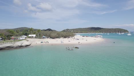 beachgoers enjoying summer activities in the great keppel island, queensland, australia