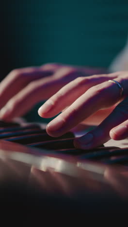 arranger engages with synthesizer closeup. proficient musician composes melody using musical instrument in audio recording studio. melodious tones