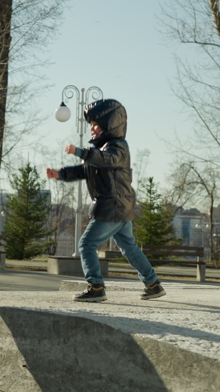A father and son playing, with the son advancing towards the father with clenched fists, with trees and lampposts in the background