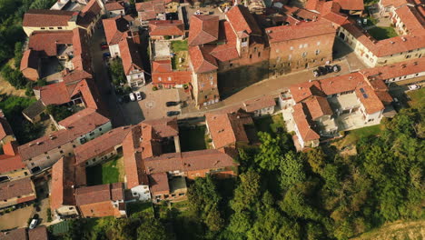 Aerial-view-rotating-away-from-the-Scurzolengo-town,-golden-hour-in-Asti,-Italy