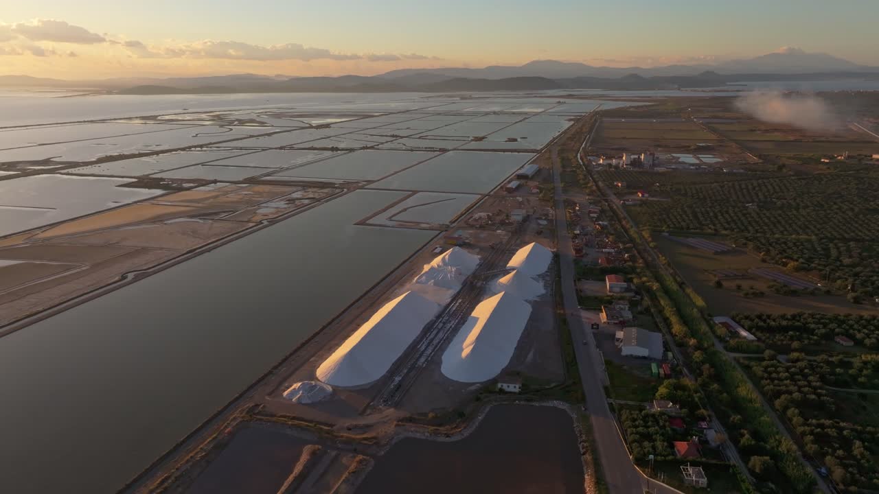 Industrial salt production site glowing at twilight, Aitoliko, Greece