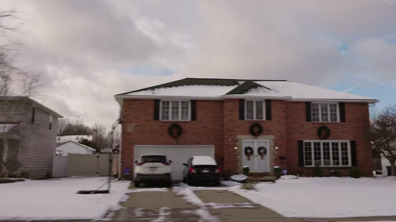 Passing Snowy Detached Homes and Garages in Suburb