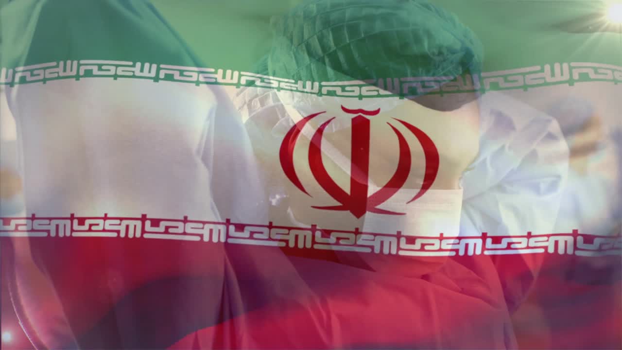 Tim kesehatan berdiri di bangsal sementara bendera Iran transparan mulai beriak menciptakan gelombang.
