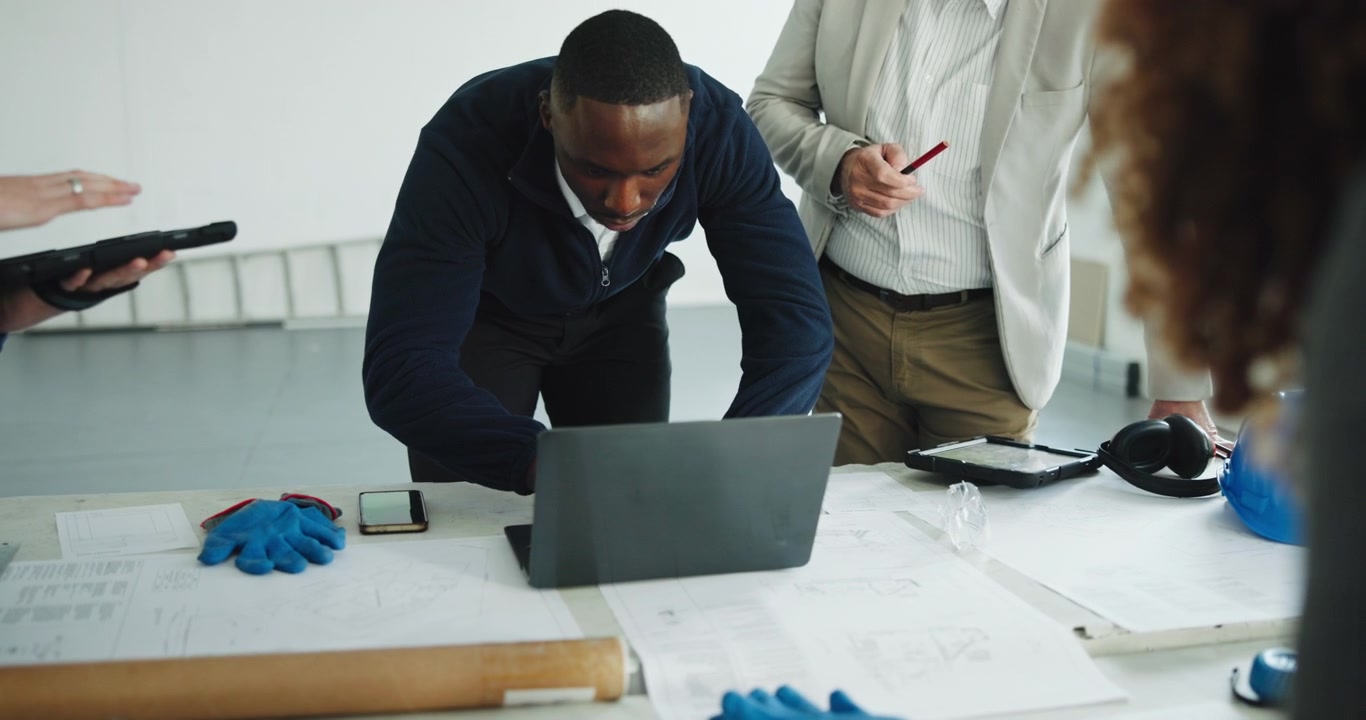 Architects and Engineers Collaborating on Construction Project in Office