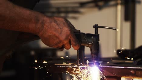 hands of welder using welding torch