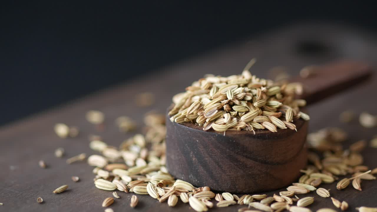 Fennel seeds in a wooden spoon