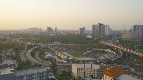 aerial view of highway street road with cars traffic and train on railway, bangkok downtown. thailand. financial district in smart urban city.