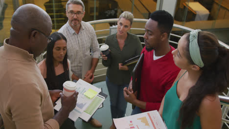 Portrait-of-happy-diverse-male-and-female-business-colleagues-with-documents