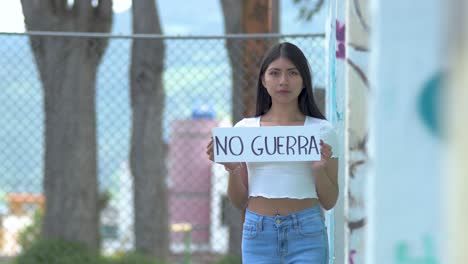 no guerra no to war sign hold by latin american woman protest activist