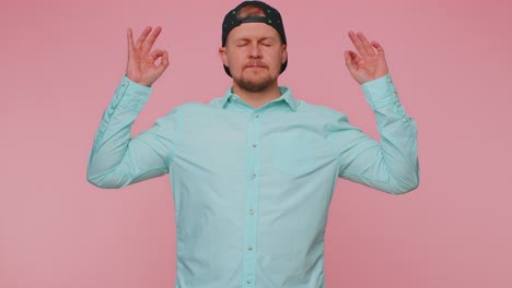 man breathes deeply with mudra gesture eyes closed meditating with concentrated thoughts peaceful