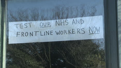 sign advocating for nhs and frontline worker testing