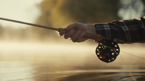 fisherman fishing in a misty morning