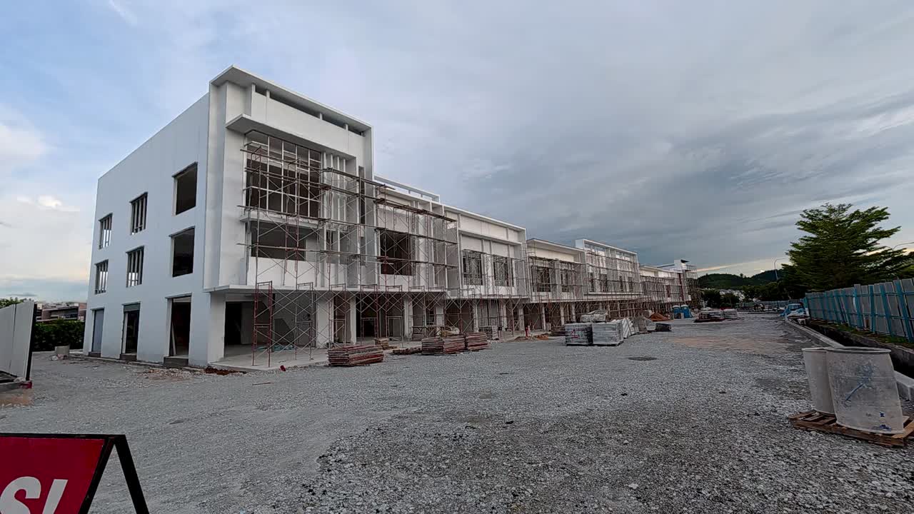 A newly built two-story shop lot in the final stage of construction with modern design, wide facade, and spacious road infrastructure.