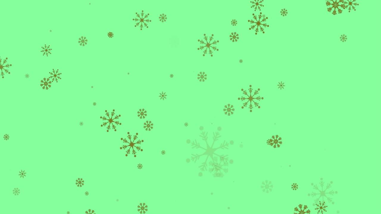 animación de copos de nieve navideños cayendo sobre un fondo verde