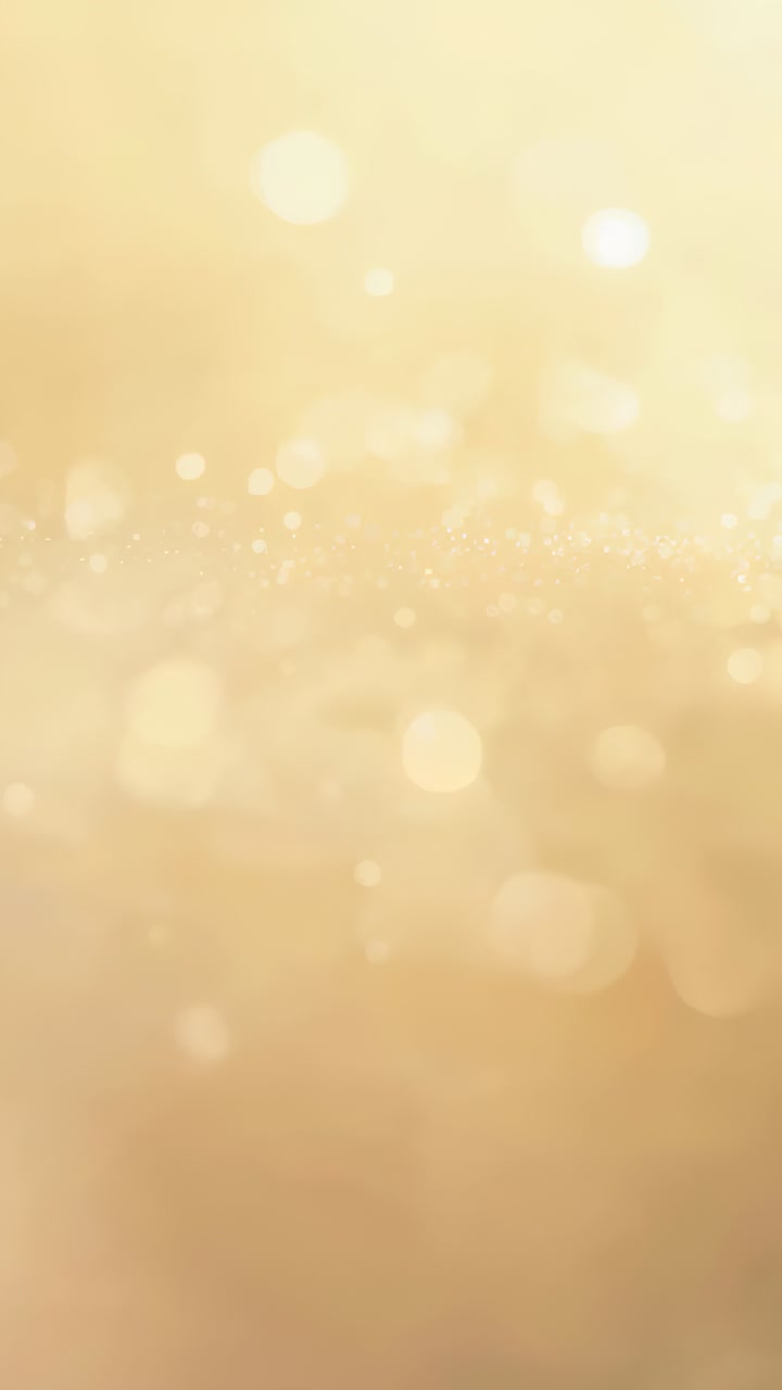 vertical-video-starting-bokeh-orbs-and-glitter-flares-shifting-on-warm