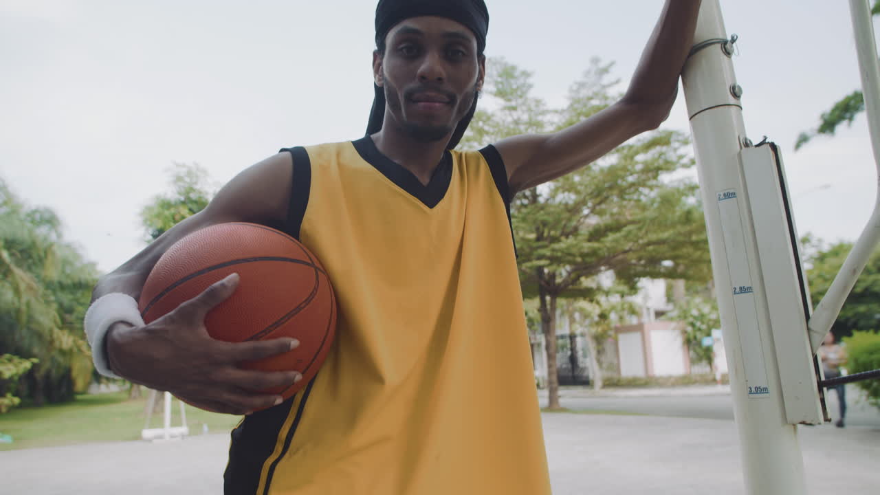 Slowmo Portrait of Black Sportsman Holding Basketball Ball