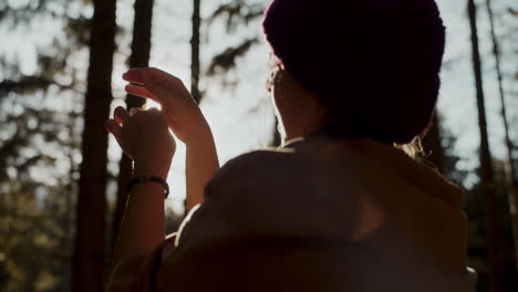 Young-explorer-gesturing-in-forest-on-sunny-day