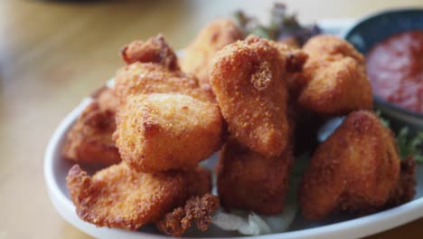 crispy fried chicken bites with red sauce