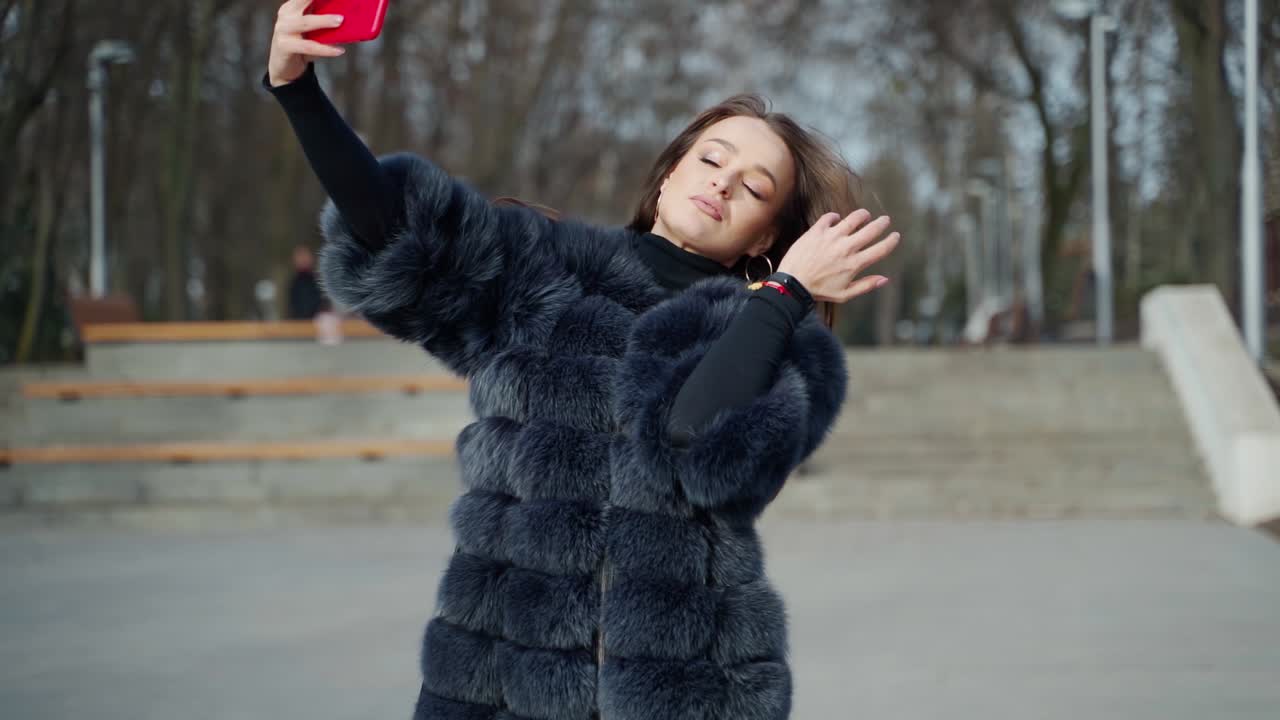 Young woman taking selfie. City stylish portrait of beautiful woman making selfie at the street