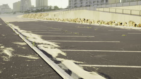 beach parking lot covered in sand at sunrise with urban backdrop