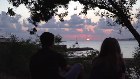 couple watching sunset at the beach