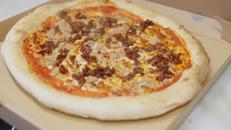 Leckere-Pizza-Auf-Offenem-Karton,-Hand-Nimmt-Ein-Stück,-Nahaufnahme,-Zoom