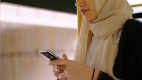 woman in hijab using mobile phone 4k