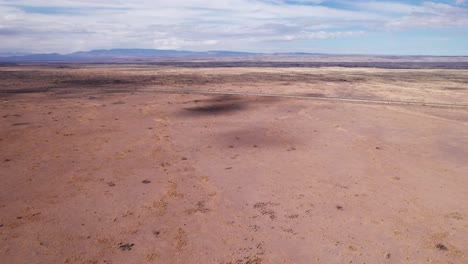 drone shot flying forward towards a remote highway in new mexico desert