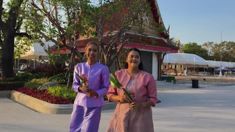 thai women in traditional attire at a temple ceremony