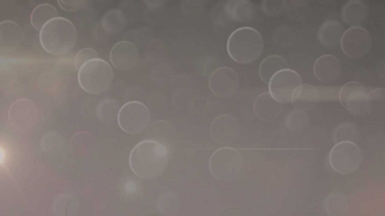 Animation of light spots and circles on grey background