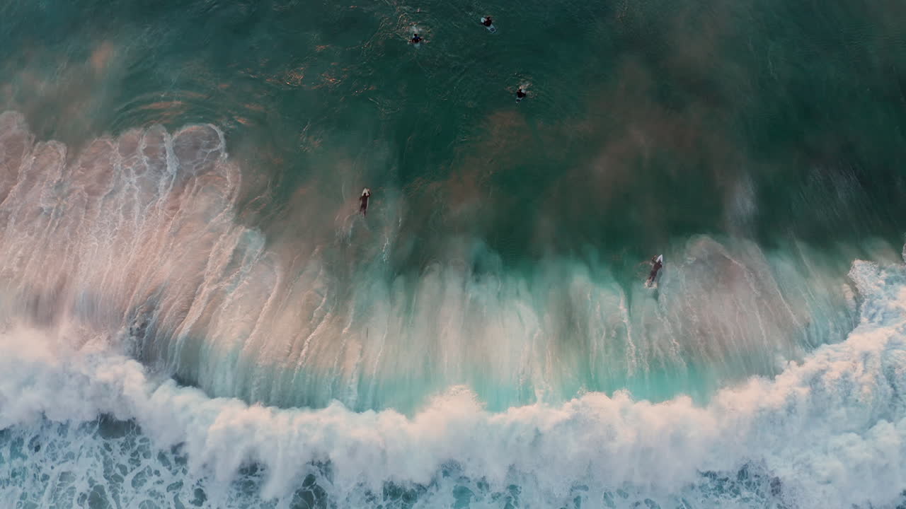 Surfers On The Wave In Llandudno Beach, Cape Town At Sunset - aerial top down