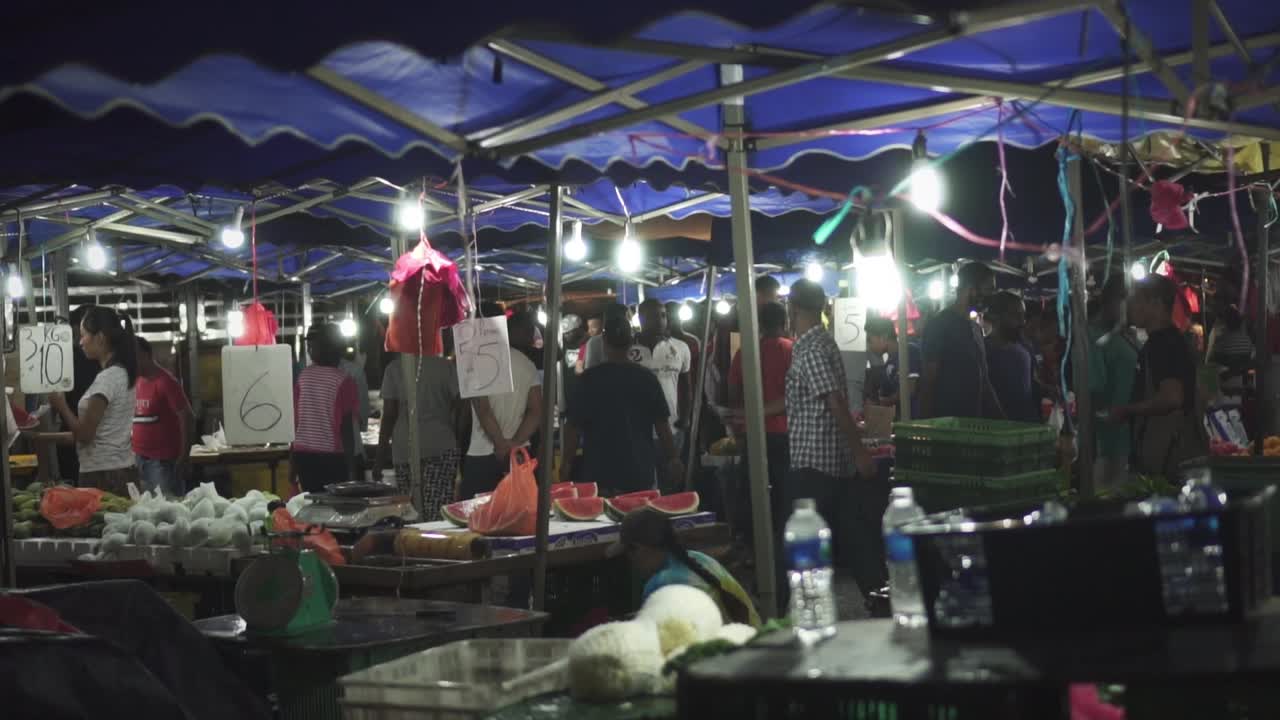 People Walking And Shopping At The Crowded Night Market After Rain In Slow Motion