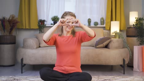 woman making heart sign at camera.