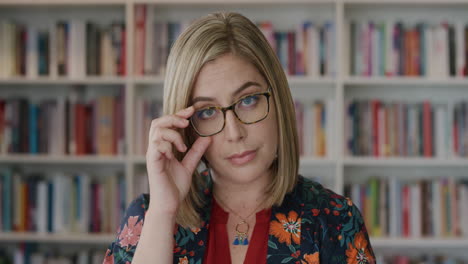 portrait intelligent young blonde woman looking serious beautiful intelligent female wearing glasses in library