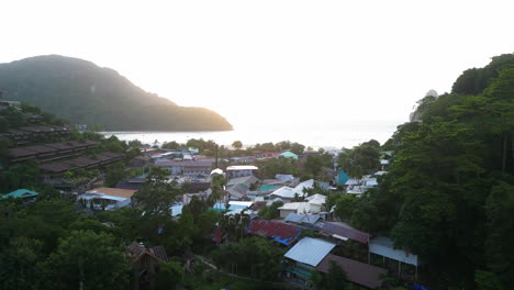 slow aerial flying backwards of city in ko phi phi islands, thailand