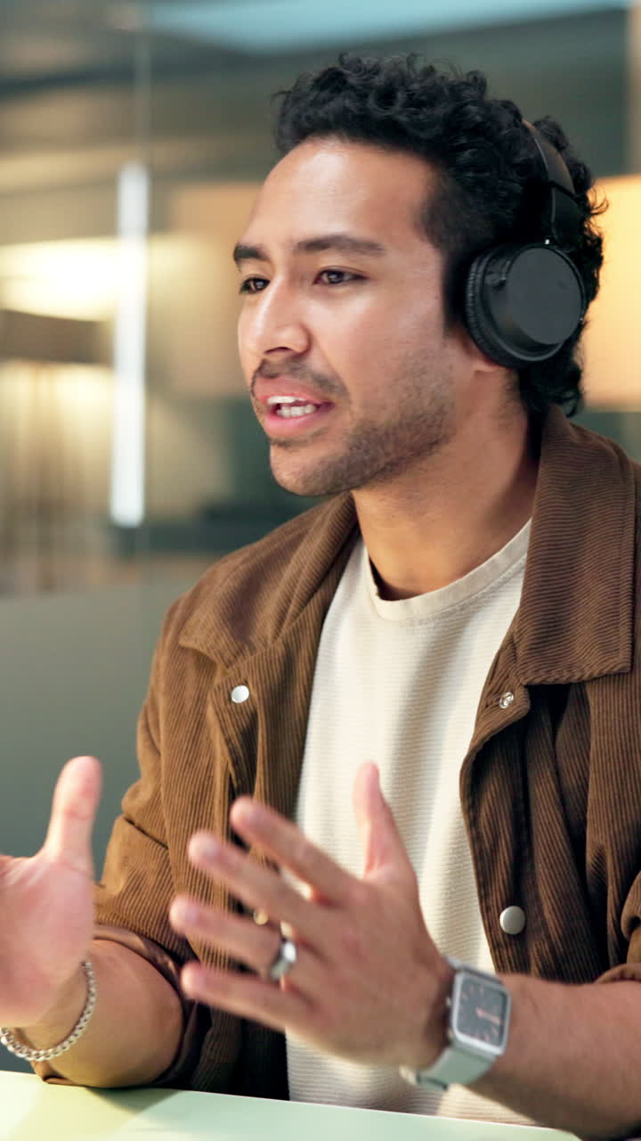 Smiling Young Man with Headphones Talking and Gesturing