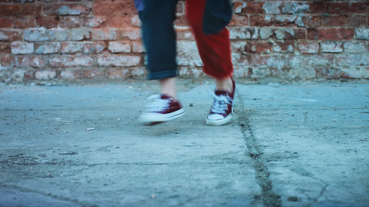 Young adult footwork dance moves. Colorful pants and retro style. 127bpm stock video