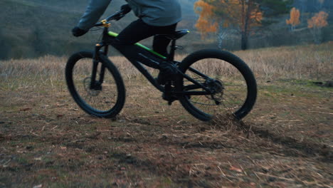 Male-Cyclist-Skidding-Riding-A-Mountain-Bike-Down-The-Road-In-The-Countryside-1