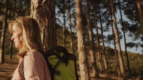 active senior woman hiking in forest