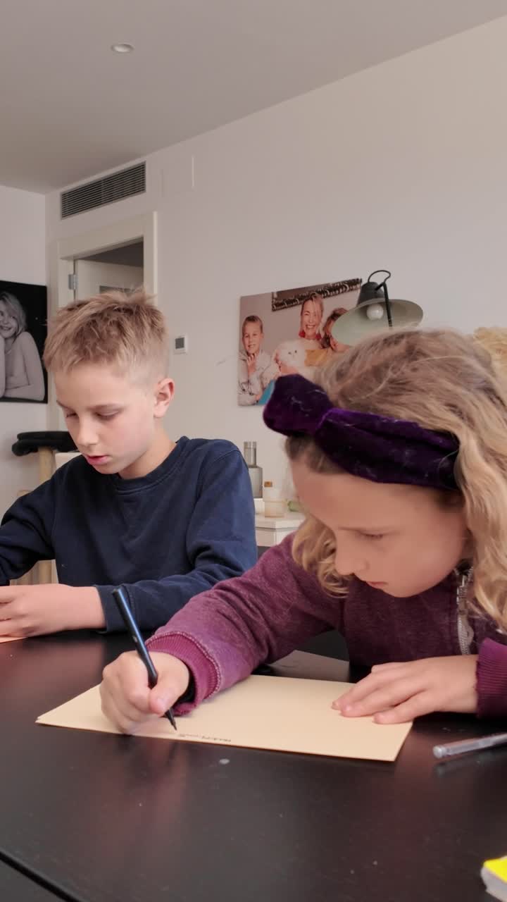 Children writing and drawing at a table indoors