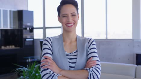 Happy-beautiful-Caucasian-female-executive-standing-with-arms-crossed-in-modern-office-4k