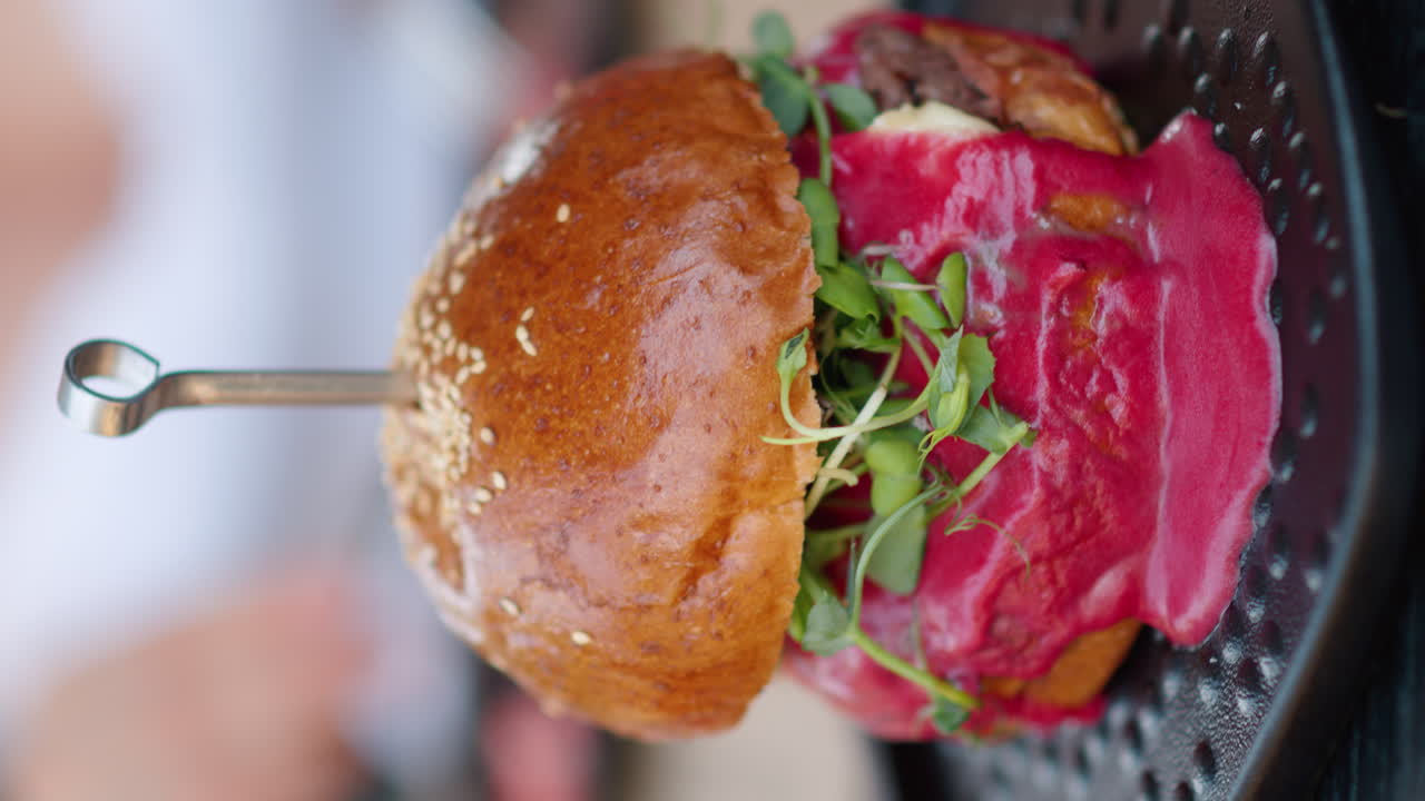 Close up burger with red sauce and green salad microplants