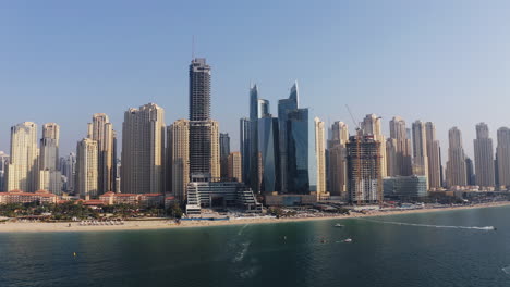 dubai skyline with beachfront and boats