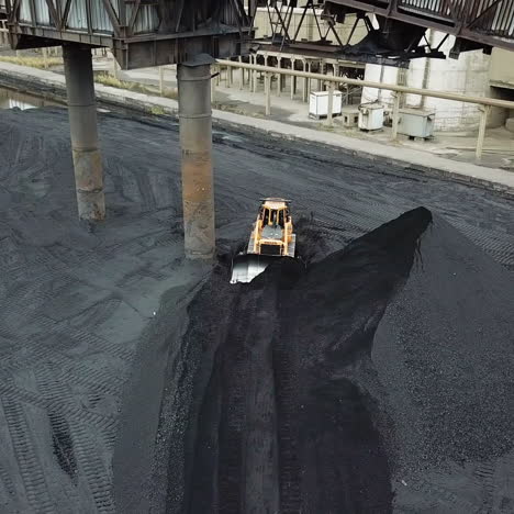 coal handling operations at the factory. crawler bulldozer works. aerial view.