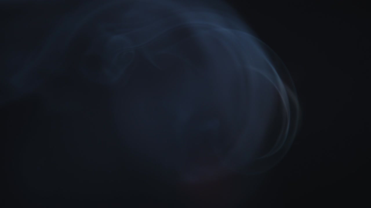 Atmospheric smoke 4K Fog effect. Smoke in slow motion on black background. White smoke slowly floating through space against black background
