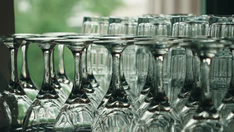 rack focus on neatly arranged wine and drink glasses for a formal event