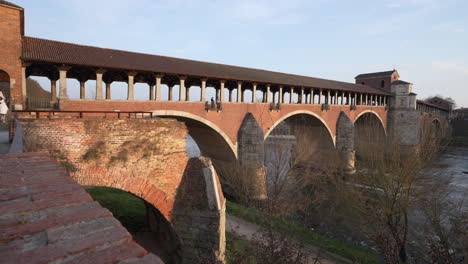 ponte coperto is a bridge over the ticino river in pavia at sunny day, lombardy, italy